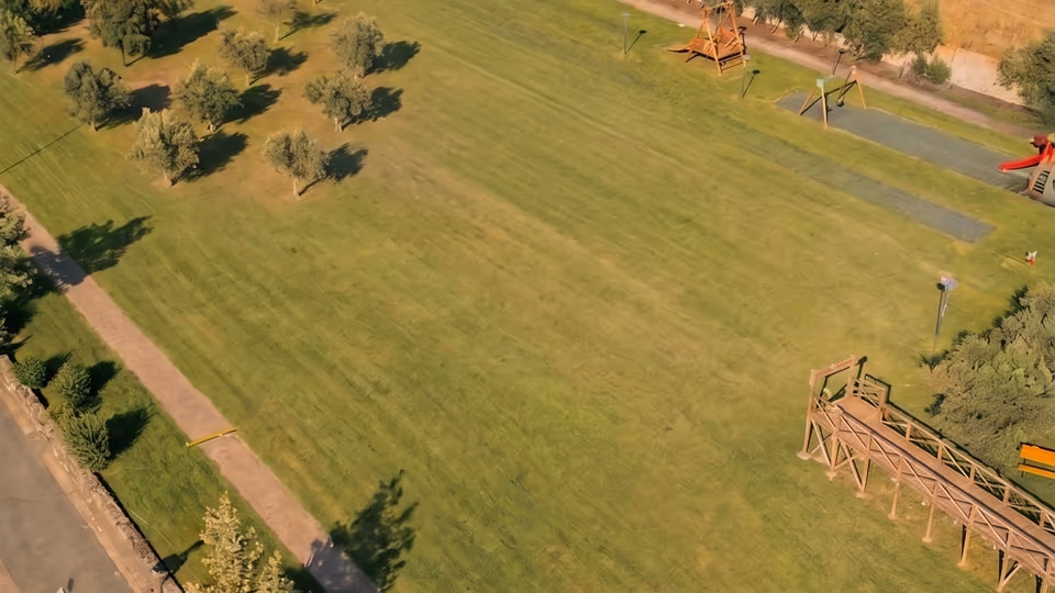 Vista dall'alto di un campo erboso vuoto prima dell'allestimento di un evento Happy Island